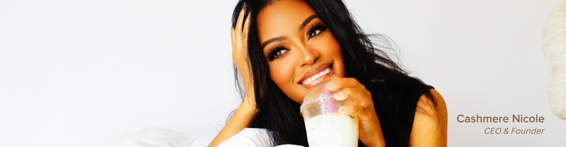 Cashmere Nicole, Founder and CEO of Beauty Bakerie is laying down smiling while drinking a milkshake. Pinktober October Breast Cancer Awareness Month Breastcancer survivor.